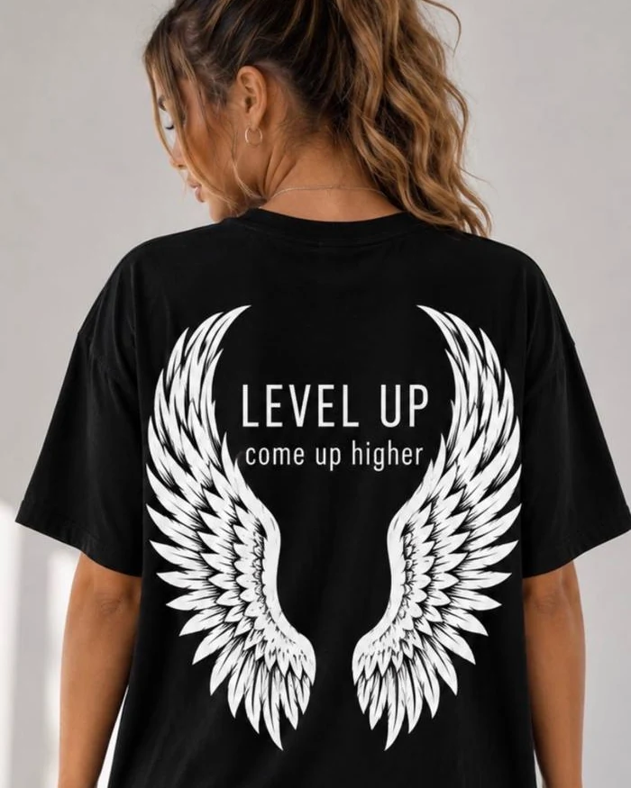 Model wearing a black Level Up shirt with a white wing design on the back